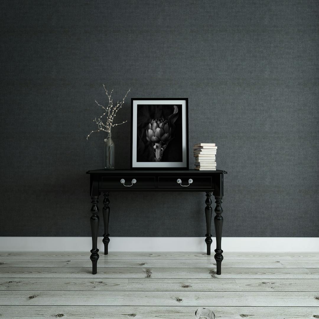 Empty frame and books on a console table