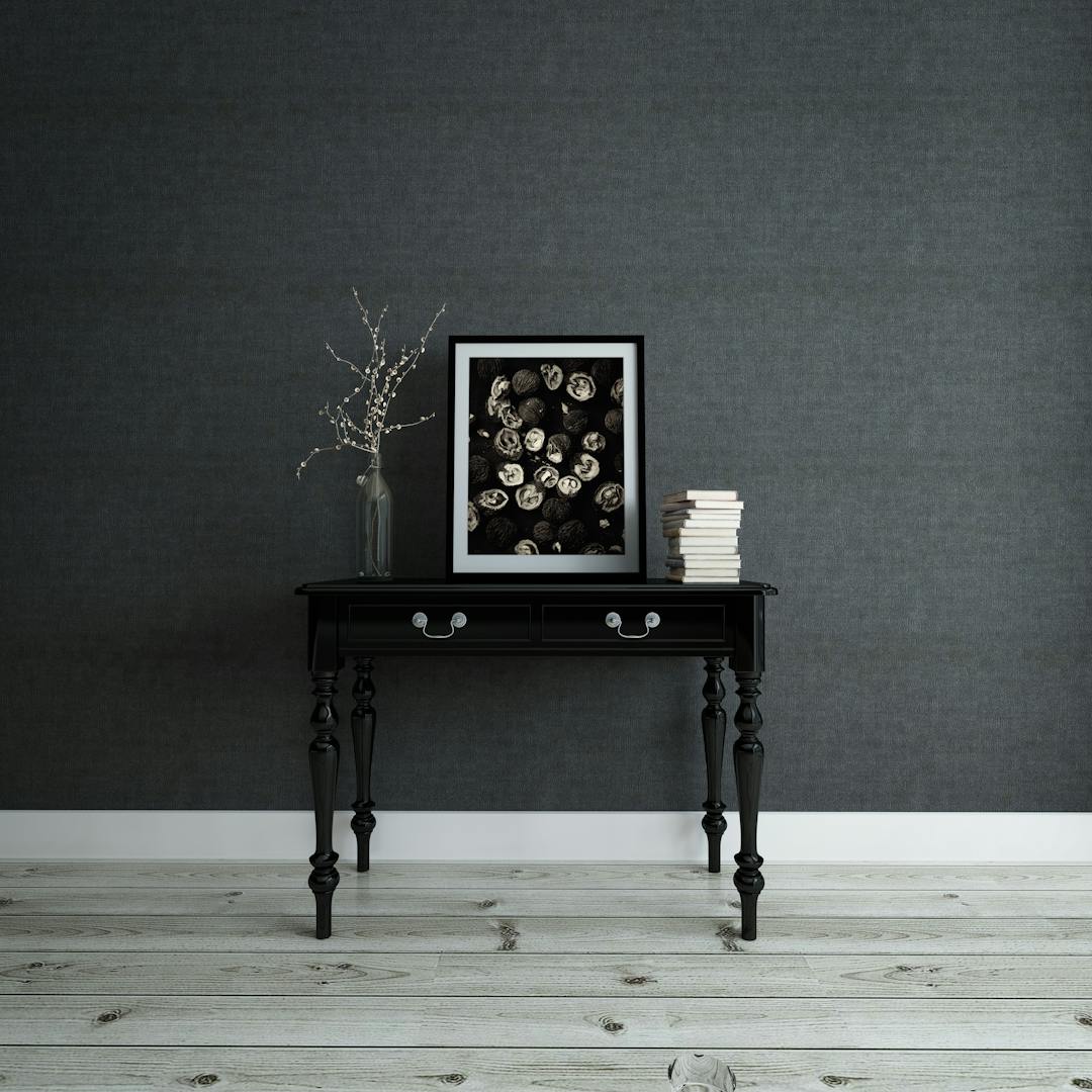 Empty frame and books on a console table